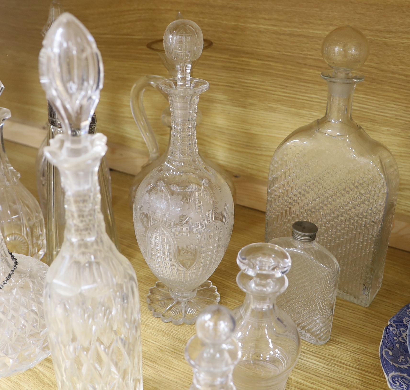 A collection of fourteen Victorian and later glass decanters, a glass funnel, a plated claret jug, coaster and scent bottle, tallest 34cm high